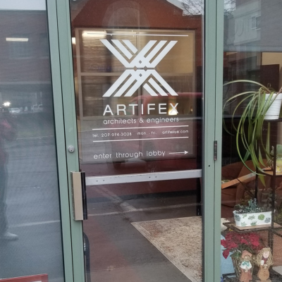 Custom contour cut vinyl decals applied to the front door of a business that was produced and installed by the team at Atlas Wrap Co.